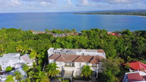 aerial flyover tropical casa colonial beach and spa resort lighting by sun in front of caribbean sea - puerto plata,dominican republic