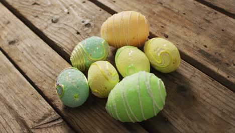 video of decorated colorful easter eggs on a wooden surface