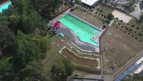 wide drone shot of swimming pool in city center 4k