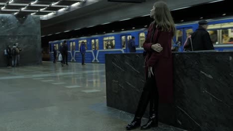 woman waiting for a train at a metro station