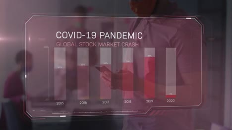 covid-19 statistical data processing against man wearing face mask using smartphone at office