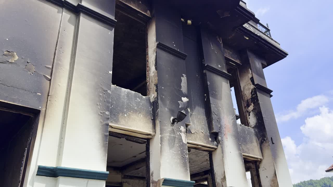 During the Gen Z protests in Kathmandu on Sept 9, 2025, a burned house displayed bold slogans — “Enough is Enough” and “End Corruption” — symbolizing youth frustration and demand for change