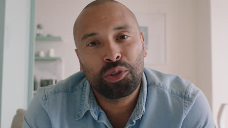 attractive hispanic man having video chat using webcam at home blowing kiss enjoying chatting to girlfriend online communication on horizontal screen