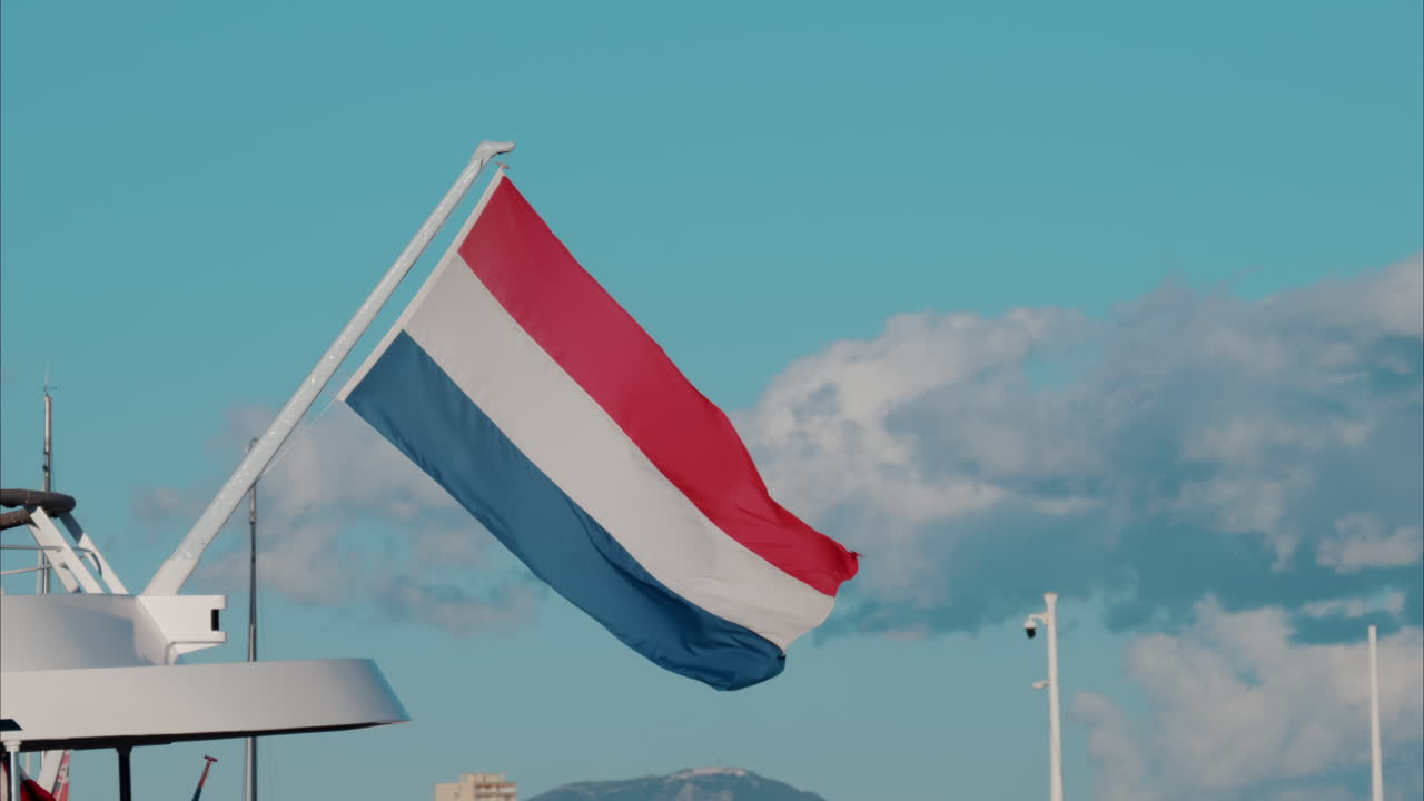 The flag of Netherlands waving on a boat docked in the Port Camille Rayon in Antibes, France