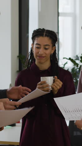 business professionals collaborating on documents in an office meeting