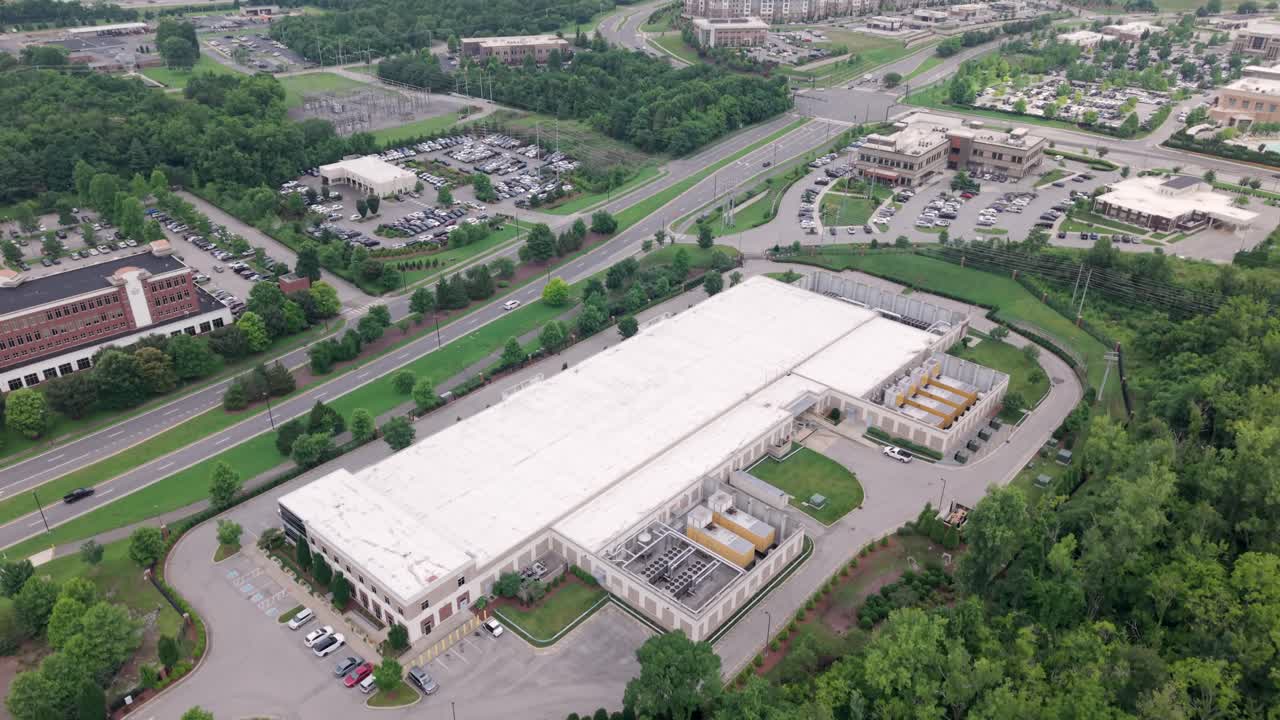 Data Center housing computer systems for servers, storage devices and networking equipment for critical infrastructure to store and distribute, aerial view