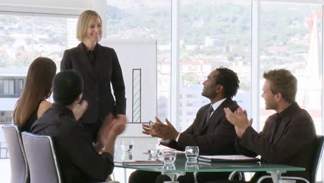 Confident-business-team-clapping-after-a-presentation