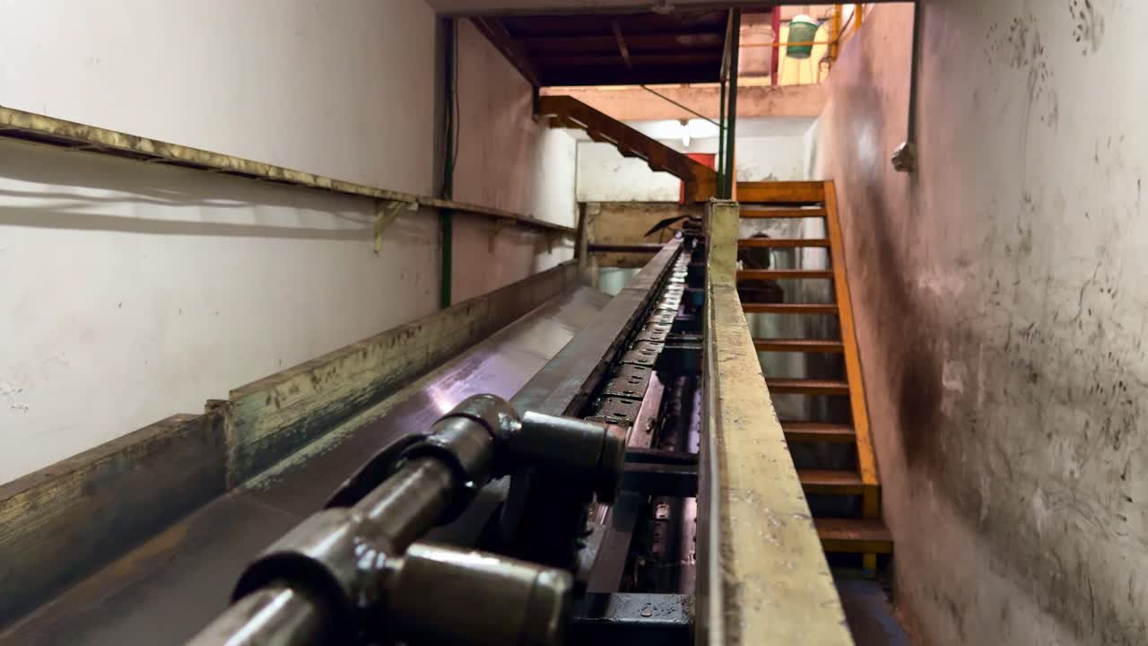 Mechanical conveyor belt transporting materials through underground industrial production line