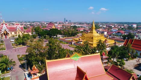 aerial vientiane laos capitol buddhism temple palace tropical palm trees city urban flying view drone footage 4k