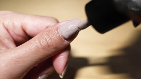 applying nail polish carefully on fingernail