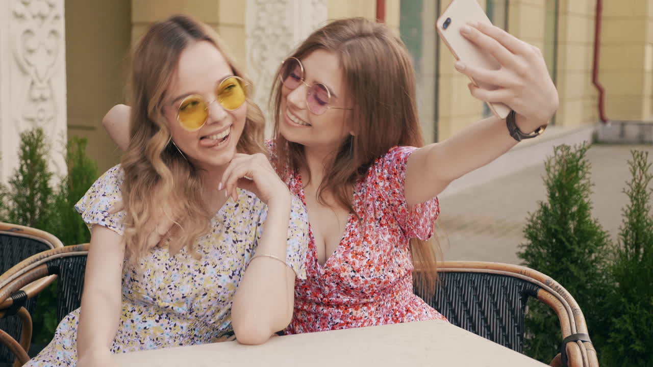 dos mujeres tomando una selfie al aire libre