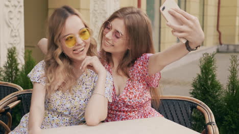 two women taking a selfie outdoors