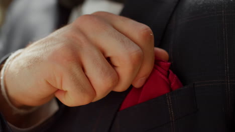 unrecognizable man touching handkerchief. man hands preparing for event.