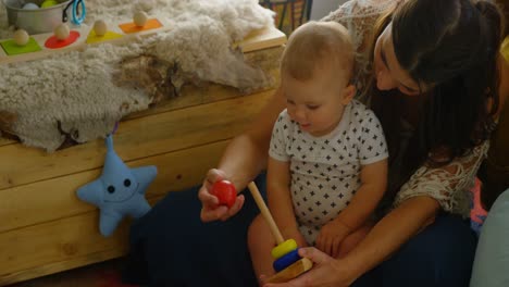 mother playing with her baby boy at home 4k