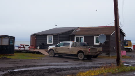 driving on the road of tuktoyaktuk inuvialuit hamlet near the mackenzie river in northwest territories, canada. pov shot