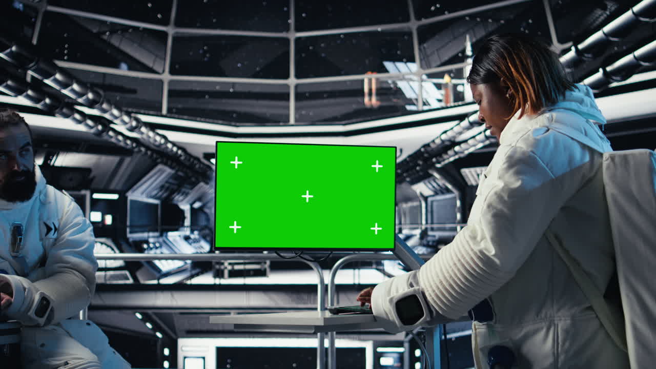 Team of cosmonauts calibrating starship sensors using isolated screen monitor