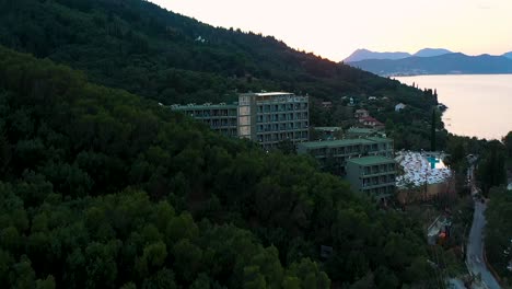 Beautiful-total-view-tracking-shot-of-coastline-Greece,-hotels,-trees,-beach,-no-people,-daylight,-a-sunny-day