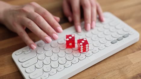 hands and dice on a keyboard