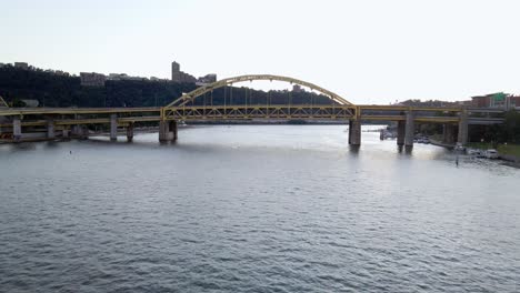 aerial drone view low towards the fort duquesne bridge on the allegheny river, in pittsburgh, usa