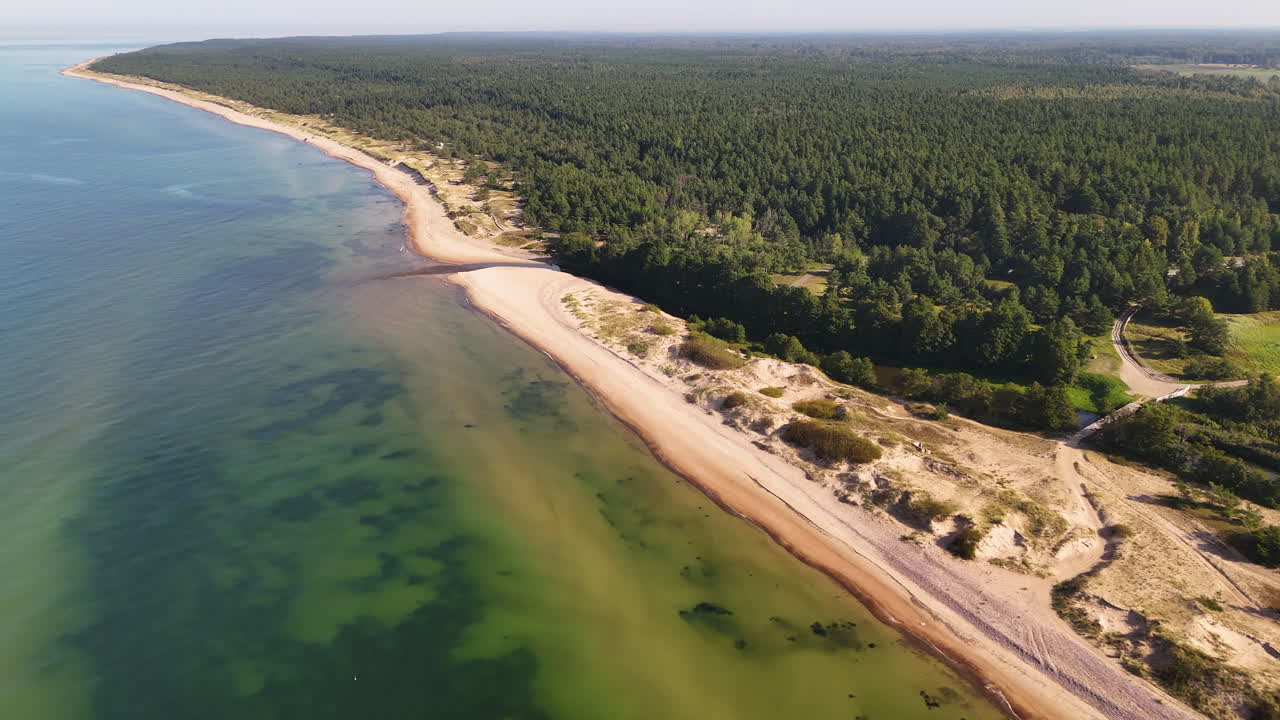 Seascape And Lush Forestland In Uzavas Ieteka Within Ventspils Municipality In The Courland Region, Latvia. Aerial Drone Shot