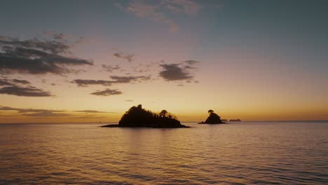 Tropical-Island-In-The-Middle-Of-Ocean-At-Sunset-In-Guanacaste,-Costa-Rica---aerial-drone-shot