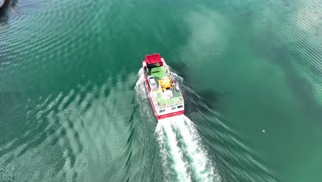 drone flying over small car ferry castletownbere west cork ireland on a bright summer morning