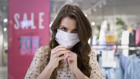 video portrait of young woman putting on a protective mask