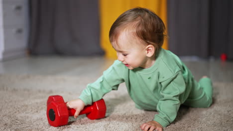 baby playing with dumbbells
