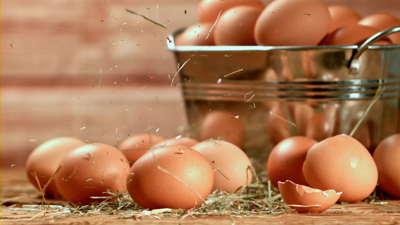 Slow Motion Hay Falling on Fresh Brown Farm Eggs