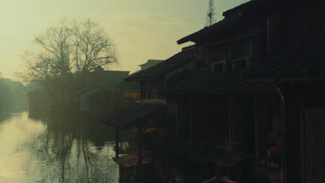 wuzhen, china, with misty reflections in water, showcasing ancient traditional houses