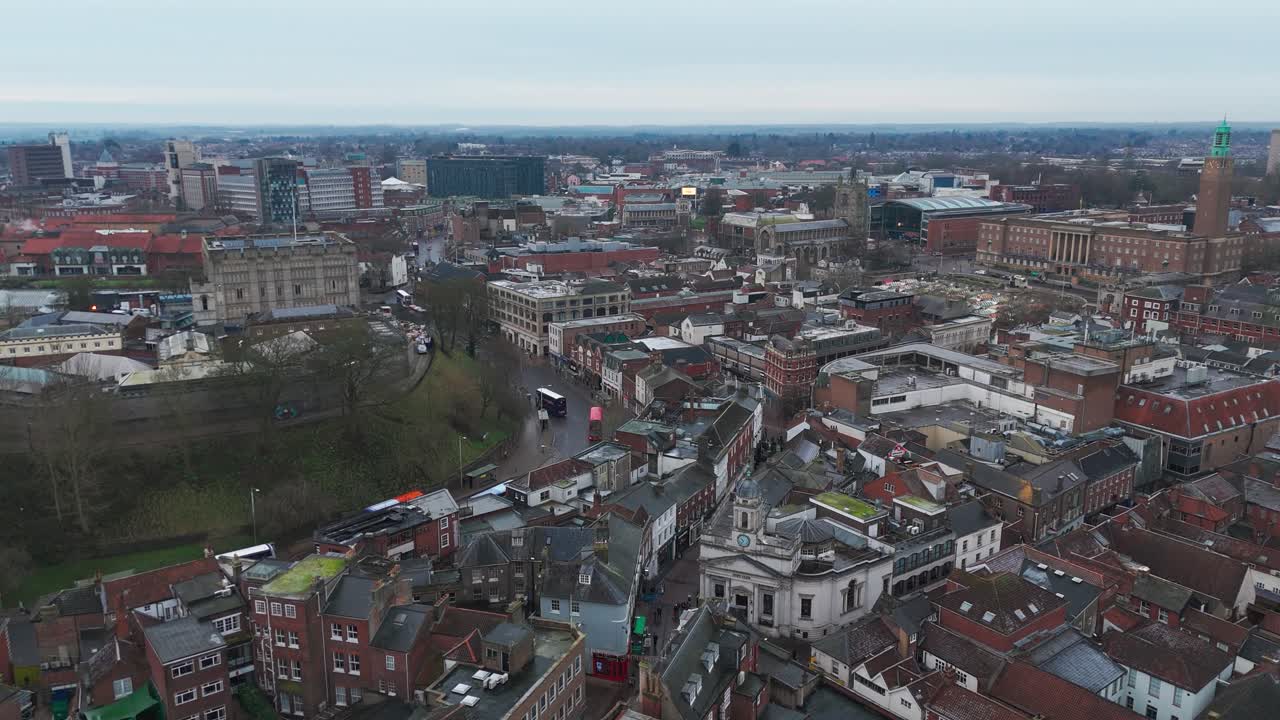 Norwich cityscape showcasing churches, streets, shops, and urban life, aerial view