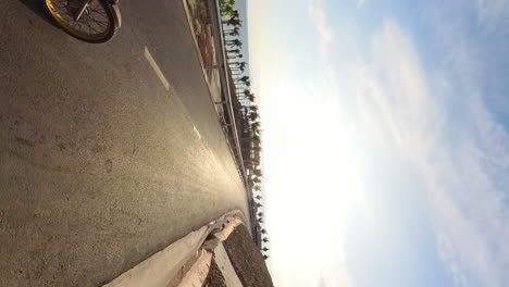 exploring vietnam, outdoor coastal adventure tours in binh thuan. motorbiker pov riding down the scenic ocean road.