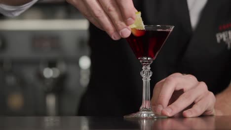 bartender preparing a red cocktail