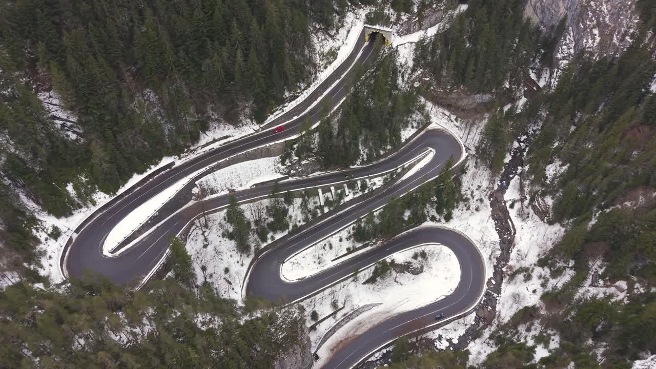 Cheile Bicazului mountain pass in Romania. The curved highway cutting through steep rock formations and woodland highlights