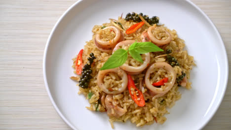 homemade basil and spicy herb fried rice with squid or octopus - asian food style