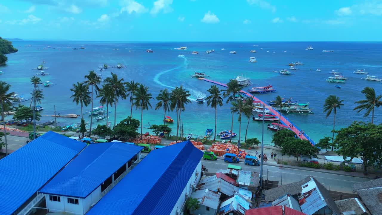 Stunning 4K aerial shot of Boracay's vibrant harbor with boats, palm trees, and turquoise waters—perfect for travel, tourism, and tropical lifestyle content