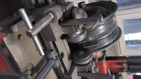 close-up of a wheel rim straightening machine