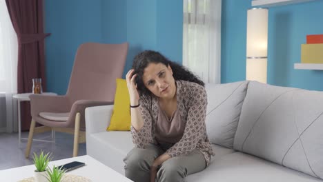 Young-woman-looking-thoughtfully-at-camera.