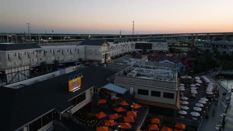 aerial view rising over restaurants at the kemah boardwalk, sunset in texas, usa