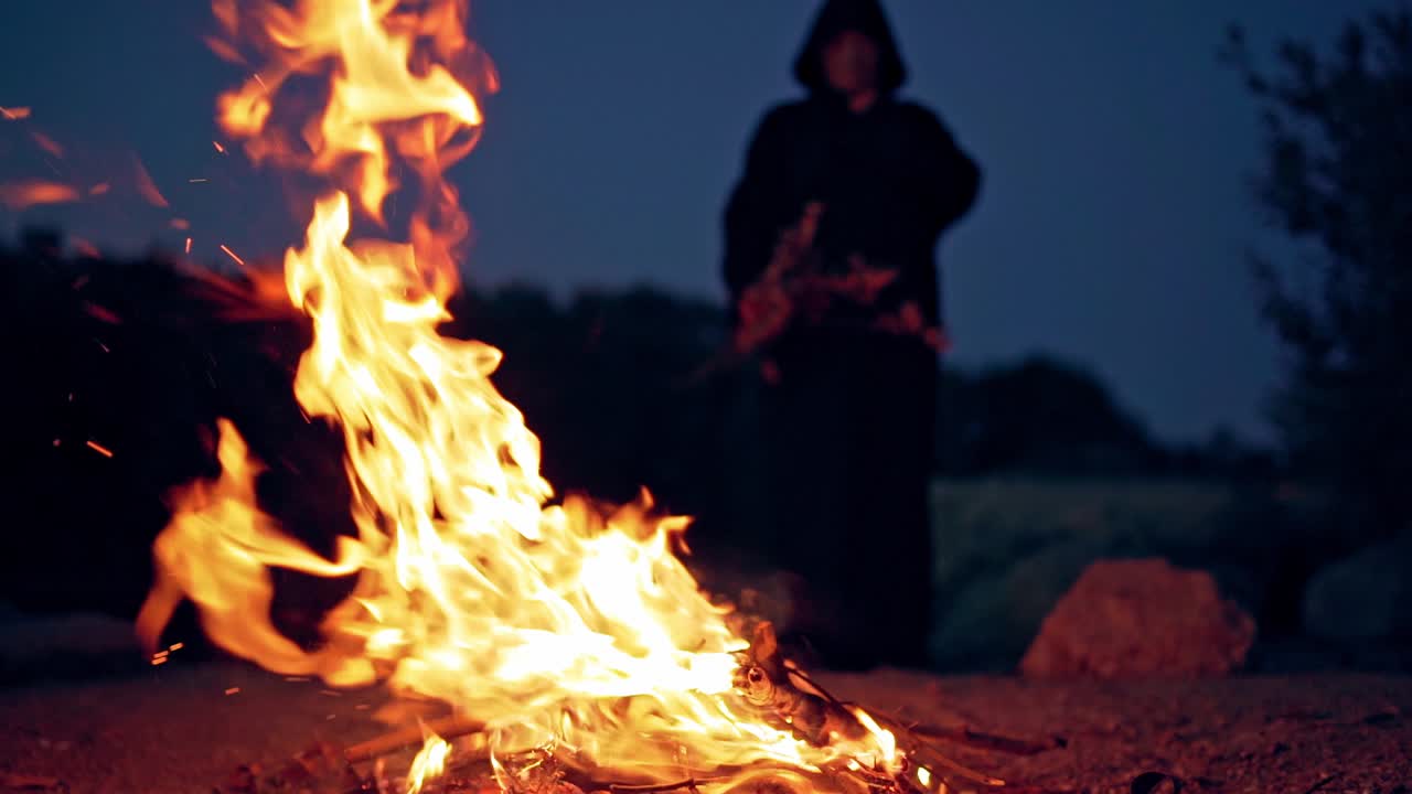 Witch near the fire. Prehistoric witch outdoors on nature