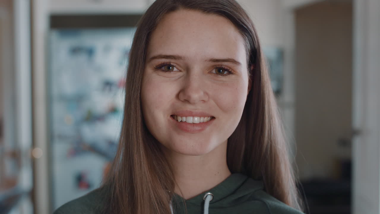 retrato de una hermosa adolescente en la cocina en casa sonriendo feliz disfrutando de un estilo de vida despreocupado