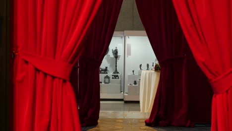 museum exhibition with red curtains