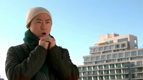 cold asian man wearing hat and scarf