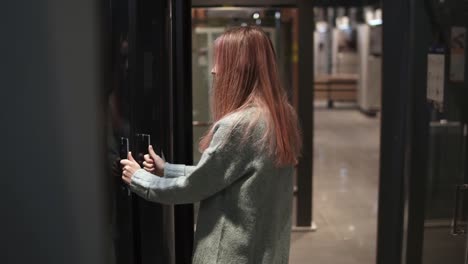 Woman-Chooses-Transparent-Doors-In-A-Hardware-Store