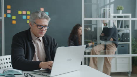 business professional working on laptop in modern office