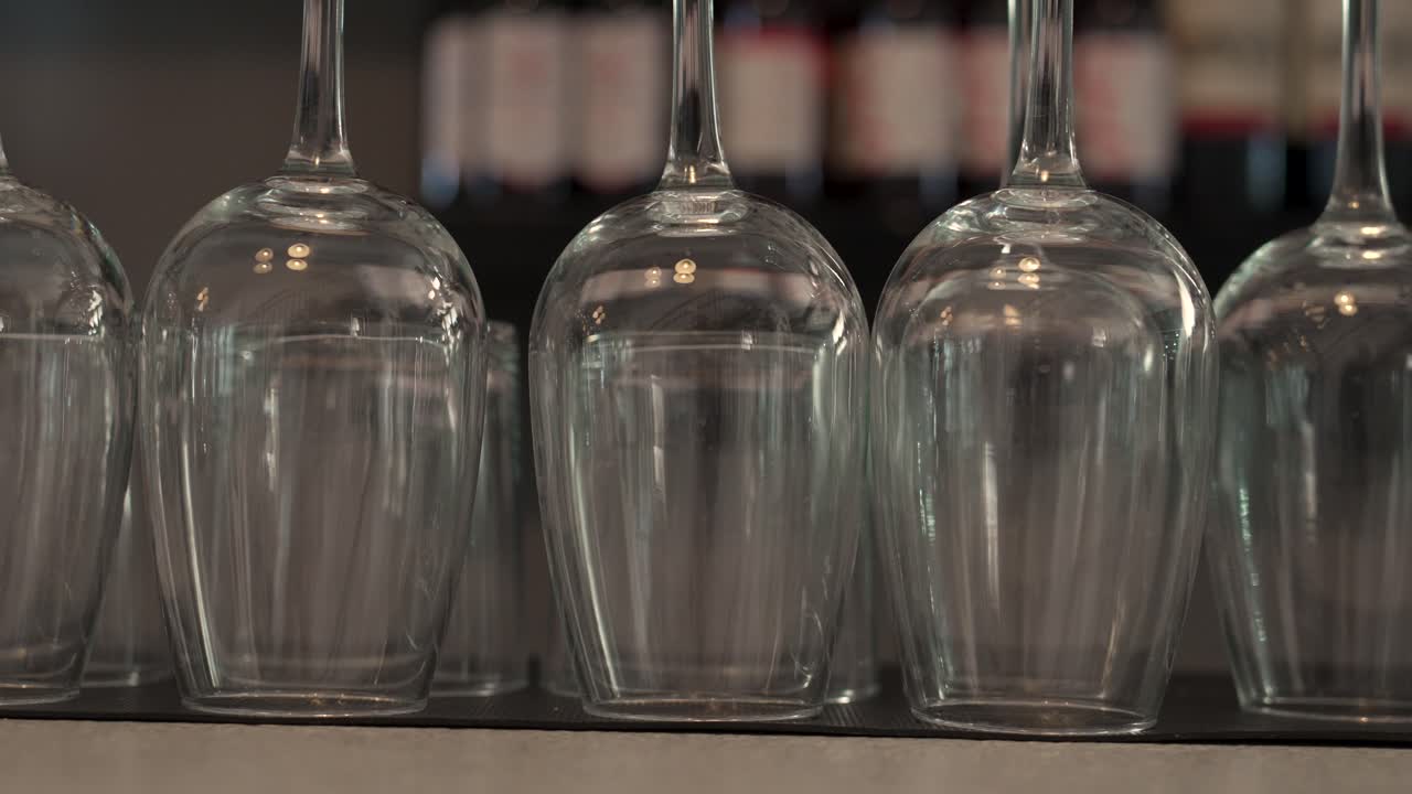 Elegant glasses arranged in a stylish setting in a cozy bar during evening hours - Close Up Shot