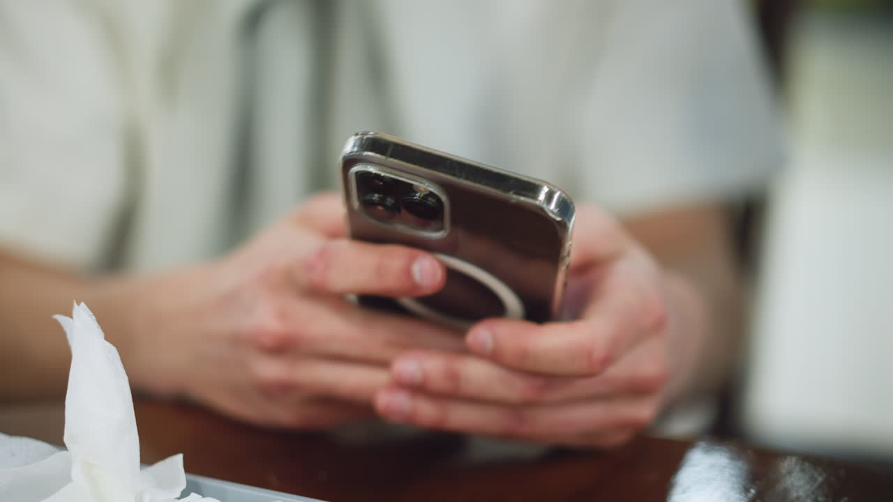 Closeup view of fresh fingers scrolling on phone screen, soft blur background, rapid touch interaction showing app content, natural skin detail and movement, modern mobile use from top angle