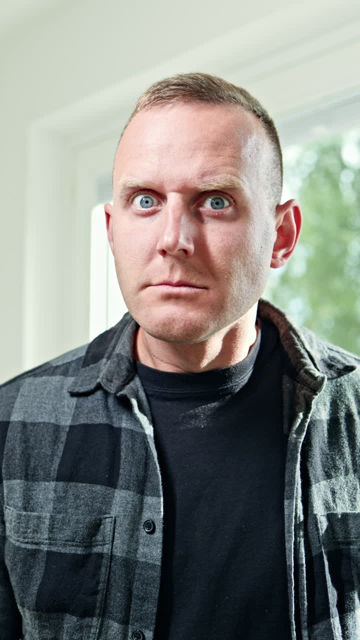 Emotional portrait of a young man close-up. The man makes various grimaces on his face