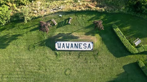 Top-Down-Drone-Shot-of-Wawanesa-Town-Sign-in-Manitoba,-Canada