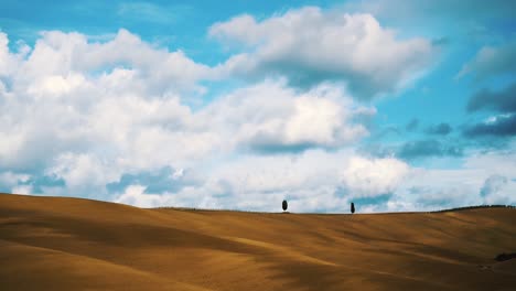 Timelapse-in-the-Tuscany-with-two-cypress-trees-on-the-hill